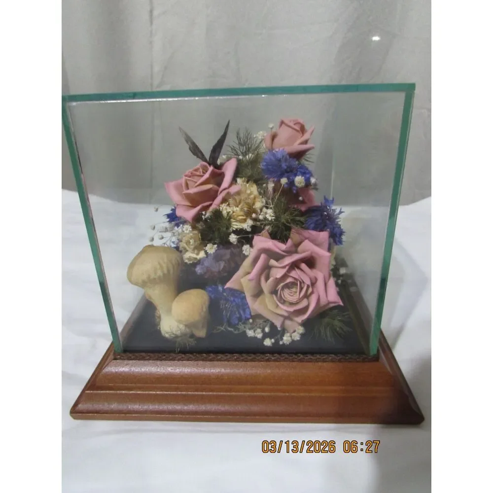 Vintage dried flower arrangement in glass with wood base butterfly mushrooms